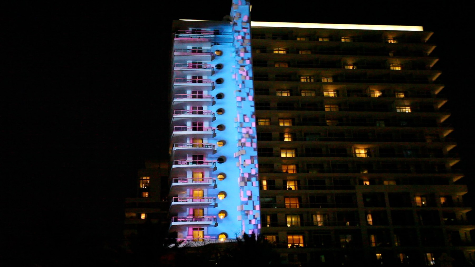 Projection rising across a building façade